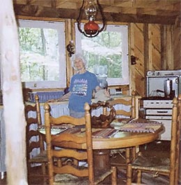 My mother in the kitchen. Oven in the background was originally gas fired, but I converted it to run on propane fuel.